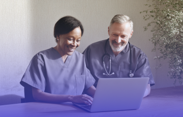 Healthcare professionals working on a laptop.